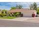 Charming single-story home with a well-manicured lawn, mature trees, and an attached two-car garage at 8851 S Juniper St, Tempe, AZ 85284