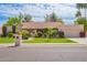 Charming single-story home with a well-manicured lawn, mature trees, and an attached two-car garage at 8851 S Juniper St, Tempe, AZ 85284