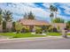 Charming single-story home with a well-manicured lawn, mature trees, and an attached two-car garage at 8851 S Juniper St, Tempe, AZ 85284