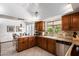 Open kitchen with tile flooring, granite countertops, and stainless steel appliances at 8851 S Juniper St, Tempe, AZ 85284