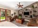 Cozy living room with stone fireplace, built-ins, ceiling fan, and plush seating at 8851 S Juniper St, Tempe, AZ 85284