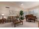 Cozy living room with plush carpeting, plantation shutters, and a grand piano at 8851 S Juniper St, Tempe, AZ 85284