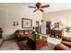 Spacious living room featuring high ceilings, a ceiling fan, and comfortable leather sofa at 8851 S Juniper St, Tempe, AZ 85284