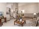 Bright living room with vaulted ceilings, plush carpeting, and staircase to the second floor at 8851 S Juniper St, Tempe, AZ 85284