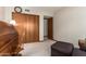 Spacious office/bedroom with a vintage rolltop desk, seating area, and sliding closet doors at 8851 S Juniper St, Tempe, AZ 85284