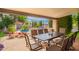 Outdoor patio features a dining area with seating and views of the pool and surrounding landscape at 8851 S Juniper St, Tempe, AZ 85284
