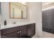 Bathroom featuring a dark vanity, framed mirror, and shower with modern fixtures at 9508 W Jj Ranch Rd, Peoria, AZ 85383