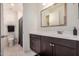 Bathroom featuring a dark vanity, framed mirror, and shower with modern fixtures at 9508 W Jj Ranch Rd, Peoria, AZ 85383