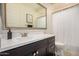 Bathroom featuring a dark vanity, framed mirror, and shower with modern fixtures at 9508 W Jj Ranch Rd, Peoria, AZ 85383