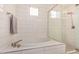 Bright bathroom with a modern tub and glass-enclosed shower, complemented by neutral tile at 9508 W Jj Ranch Rd, Peoria, AZ 85383