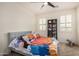 Stylized bedroom featuring grey upholstered bed, playful decor, and carpeted floors at 9508 W Jj Ranch Rd, Peoria, AZ 85383