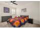 Bright bedroom featuring full-sized bed, ceiling fan, and ample natural light at 9508 W Jj Ranch Rd, Peoria, AZ 85383
