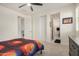 Bedroom with closet, access to bathroom, white walls, and ceiling fan at 9508 W Jj Ranch Rd, Peoria, AZ 85383