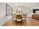 Bright dining room features a chandelier and a large dining table that seats ten under a modern light fixture at 9508 W Jj Ranch Rd, Peoria, AZ 85383