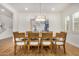 Dining room with a large table surrounded by eight chairs and decorative chandelier at 9508 W Jj Ranch Rd, Peoria, AZ 85383