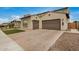 Expansive three-car garage and brick-paved driveway offer ample parking at this beautiful home at 9508 W Jj Ranch Rd, Peoria, AZ 85383