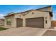 Spacious three-car garage with brick-paved driveway enhances the curb appeal of this lovely home at 9508 W Jj Ranch Rd, Peoria, AZ 85383