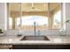 The kitchen sink has granite countertops and a beautiful view from the window at 9508 W Jj Ranch Rd, Peoria, AZ 85383