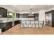This modern kitchen features a large island, stainless steel appliances, and stylish dark wood cabinetry at 9508 W Jj Ranch Rd, Peoria, AZ 85383
