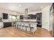 Gourmet kitchen with stainless steel appliances, a large island, and plenty of dark wood cabinets at 9508 W Jj Ranch Rd, Peoria, AZ 85383