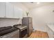 Laundry room with sleek appliances, counter space, and overhead cabinets at 9508 W Jj Ranch Rd, Peoria, AZ 85383