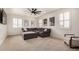 Spacious living room with a large sectional couch, shutters, and ceiling fan at 9508 W Jj Ranch Rd, Peoria, AZ 85383