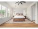 Cozy main bedroom featuring wood-look flooring, plantation shutters, and ensuite bath access at 9508 W Jj Ranch Rd, Peoria, AZ 85383