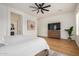 Bright and spacious main bedroom with wood-look flooring, ceiling fan, and ensuite bath at 9508 W Jj Ranch Rd, Peoria, AZ 85383
