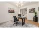 Bright and stylish office featuring modern decor, a cozy rug, and convenient access to the staircase at 9508 W Jj Ranch Rd, Peoria, AZ 85383