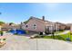 Lush backyard with swimming pool, artificial turf, and patio area, perfect for outdoor living and entertaining at 1147 N Marvin St, Gilbert, AZ 85233