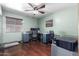 Bedroom featuring hardwood floors, ceiling fan, and neutral color scheme at 1147 N Marvin St, Gilbert, AZ 85233