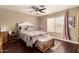 Bedroom with hardwood floors, natural lighting from the window, and ceiling fan at 1147 N Marvin St, Gilbert, AZ 85233