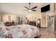 The primary bedroom features hardwood floors, a TV, a ceiling fan, and private patio access at 1147 N Marvin St, Gilbert, AZ 85233