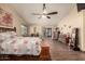 Bedroom with dark-stained hardwood floors, a window, a ceiling fan, and private patio access at 1147 N Marvin St, Gilbert, AZ 85233