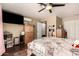 Bedroom with hardwood floors, natural lighting from the window, a TV, and ceiling fan at 1147 N Marvin St, Gilbert, AZ 85233