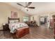 Spacious bedroom features a ceiling fan, access to the patio, and wood-look flooring at 1147 N Marvin St, Gilbert, AZ 85233