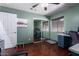 Bedroom featuring hardwood floors, ceiling fan, and a closet with mirrored sliding doors at 1147 N Marvin St, Gilbert, AZ 85233