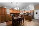 Open kitchen with wood cabinets, stainless appliances, island, and adjacent dining area at 1147 N Marvin St, Gilbert, AZ 85233