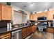 Featuring a stainless steel dishwasher, gas cooktop, oven, microwave, and dual basin sink at 1147 N Marvin St, Gilbert, AZ 85233