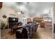 Open-concept living room with tile floors, ceiling fan, providing a seamless flow to the adjacent kitchen area at 1147 N Marvin St, Gilbert, AZ 85233