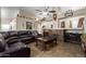 Inviting living room features a stacked stone fireplace, vaulted ceilings, and tiled floors at 1147 N Marvin St, Gilbert, AZ 85233