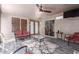 Enclosed patio featuring comfortable seating, ceiling fan, and tile flooring for year-round enjoyment at 1147 N Marvin St, Gilbert, AZ 85233