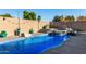 Sparkling pool and spa area with rock waterfall, string lights, and desert landscaping for a resort-like experience at 1147 N Marvin St, Gilbert, AZ 85233