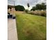 Expansive backyard with green lawn and mature landscaping at 135 S Abalone Dr, Gilbert, AZ 85233