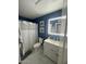 Bathroom featuring white vanity, toilet, blue walls, and lighted mirror at 135 S Abalone Dr, Gilbert, AZ 85233
