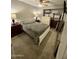 Cozy bedroom with neutral walls and carpet, ample furniture, and a ceiling fan at 135 S Abalone Dr, Gilbert, AZ 85233