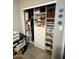 Walk-in closet with built-in shelves for clothes and accessories at 135 S Abalone Dr, Gilbert, AZ 85233