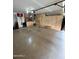 A large, clean garage featuring built-in storage cabinets, speckled flooring, and ample space for parking and storage at 135 S Abalone Dr, Gilbert, AZ 85233