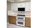 Modern kitchen featuring stainless steel appliances, a double oven, and white marble floors at 135 S Abalone Dr, Gilbert, AZ 85233