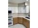 Kitchen featuring stainless steel appliances, a corner sink, and white marble floors at 135 S Abalone Dr, Gilbert, AZ 85233